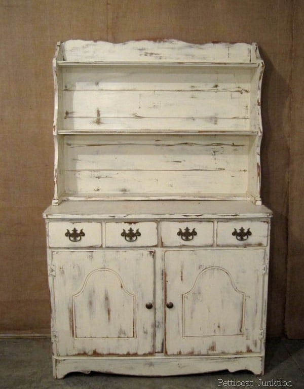 white hutch with distressed paint