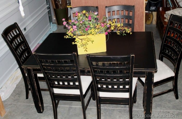 distressed black chairs with drop cloth seats
