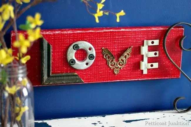 Make this red love wall decor diy craft from things found in your junk drawer or garage.