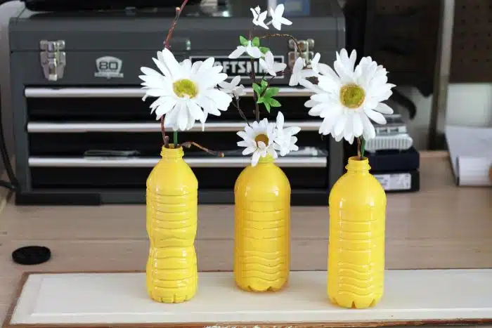 flowers in painted water bottles