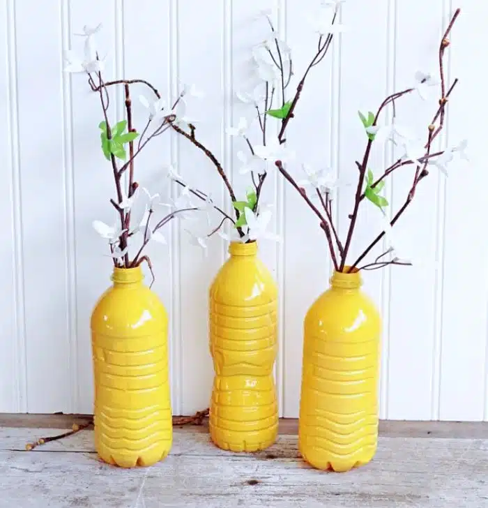 Recycled Water Bottle Vases Created With Spray Paint And Ribbon