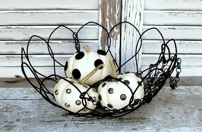 small white pumpkins decorated with tacks