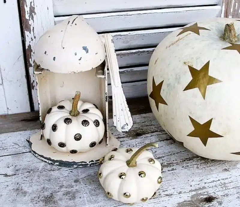 white pumpkins decorated with sticky gold stars