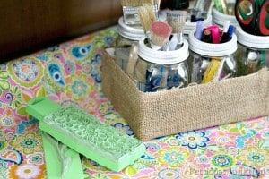 recycle a cardboard box and cover it with burlap to make an organizer