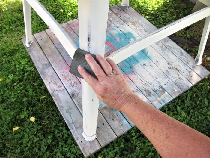 how to distress painted metal furniture with a sanding block