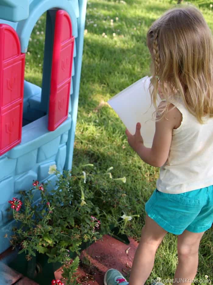 Sofi watering flowers