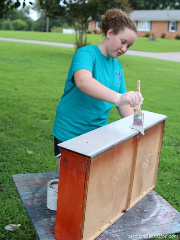 Granddaughter painting furniture