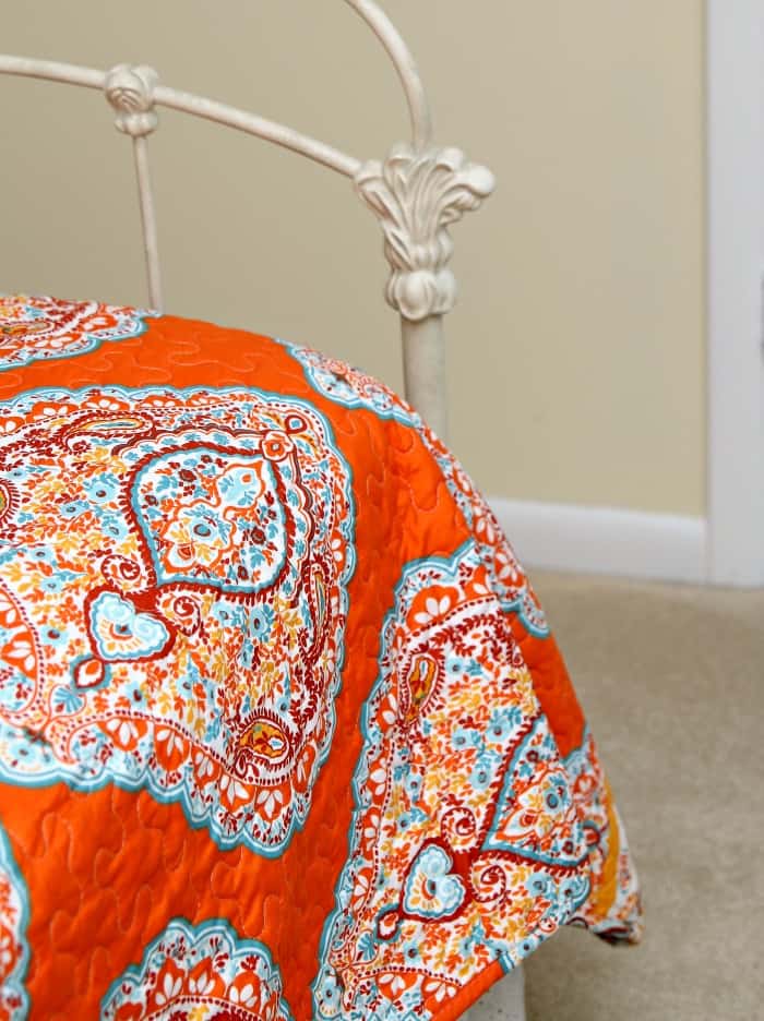 bedroom decorated in orange and turquoise