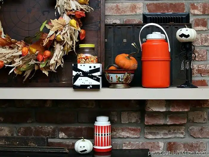 Fall mantel decorations featuring vintage finds and white pumpkins