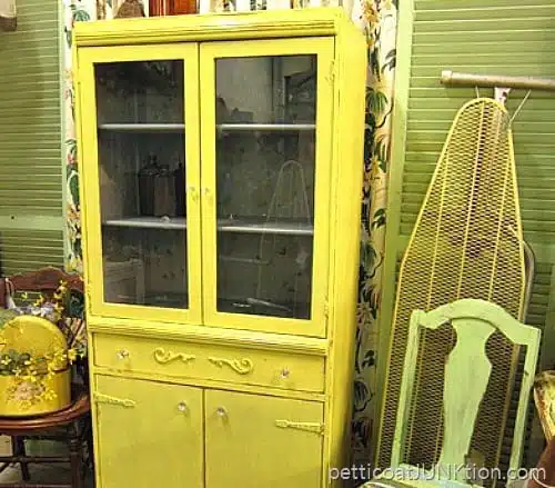 yellow cabinet painted with gray primer on the interior