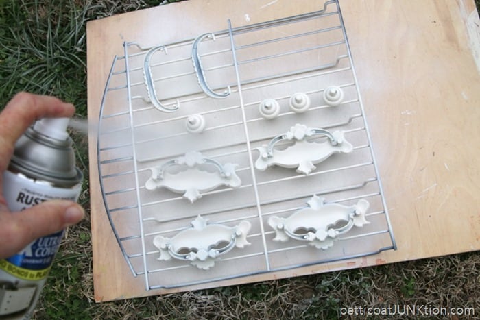 Spray painting drawer pulls with White Rustoleum Spray Paint