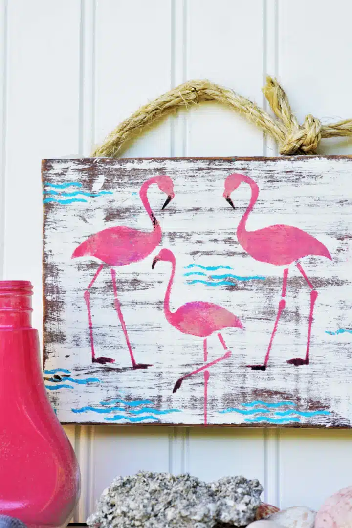 Pink flamingos stenciled sign