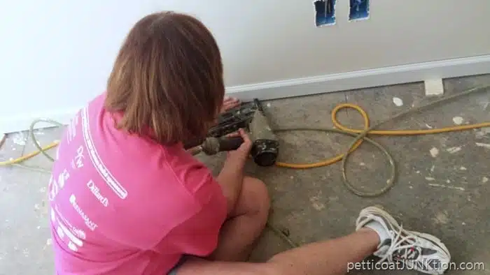 installing floor molding in Habitat for Humanity home Nashvillle Women Build 2017