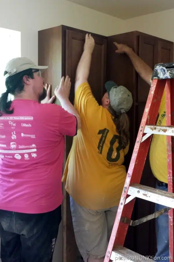 installing kitchen cabinets in Habitat for Humanity home
