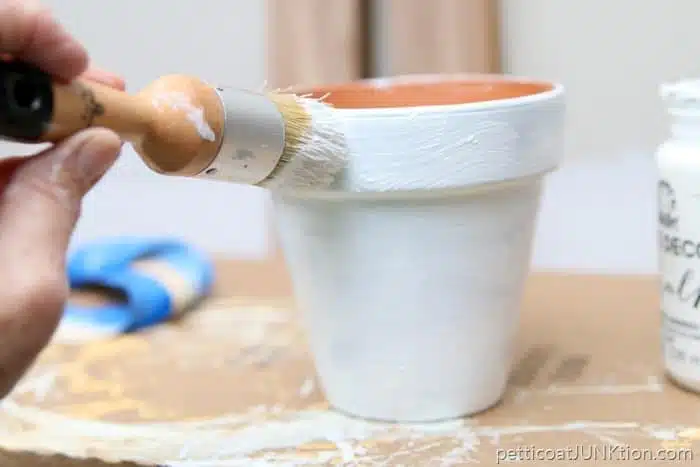 painting a clay pot