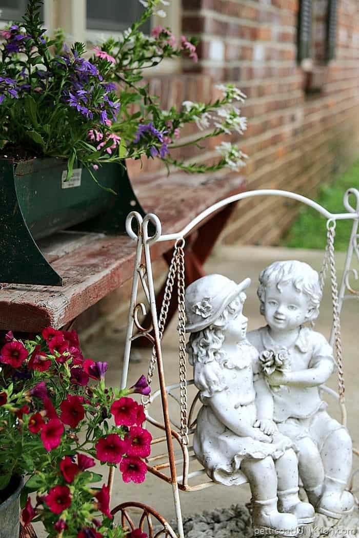 fancy flowers in rusty containers for porch decorating