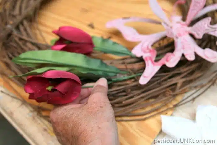 stick the flower stems in the grapevine wreath