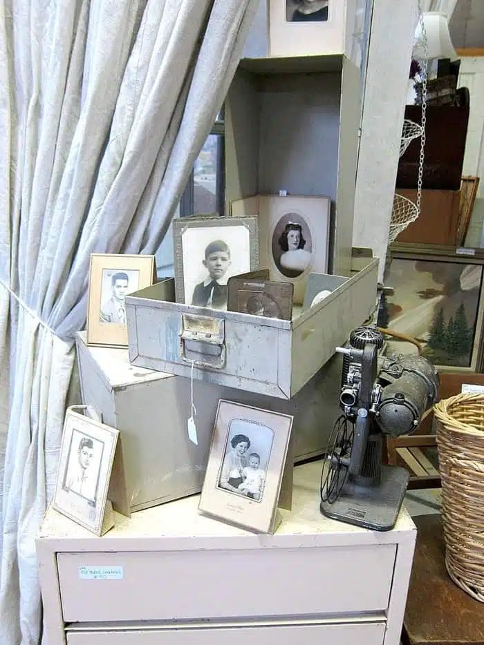 display with old photographs and metal drawers
