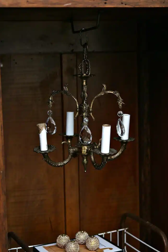 hang a vintage chandelier in wood wardrobe