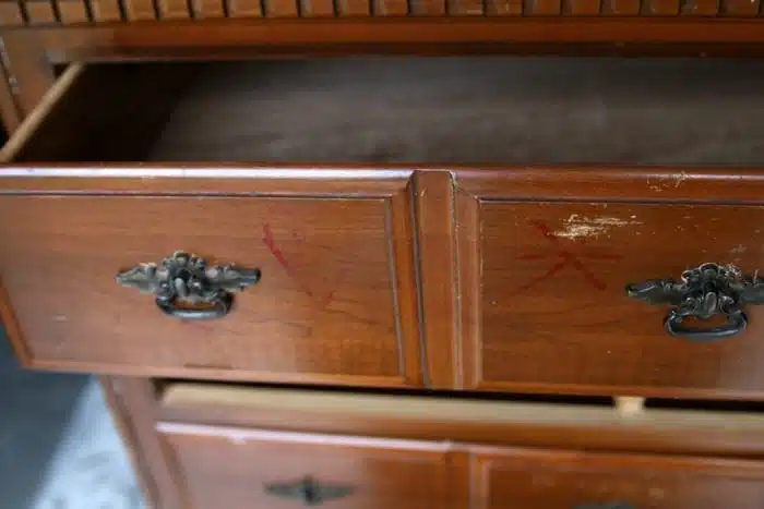 permanent ink and names scratched on drawer fronts