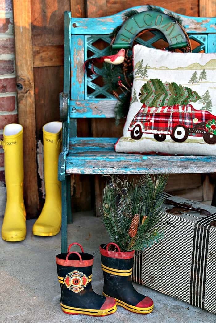 decorating the front porch with boots and vintage items like the suitcase