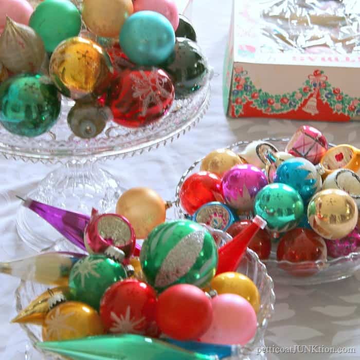 Chrismtas ornaments displayed on glass cake stands