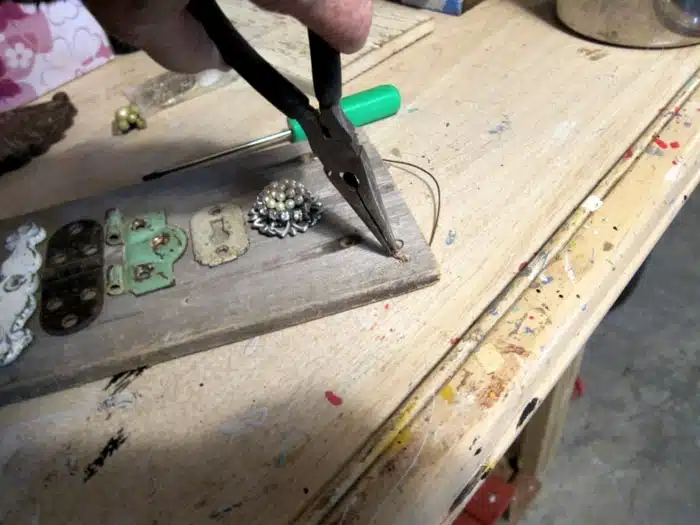 attaching a wire hanger to wall art