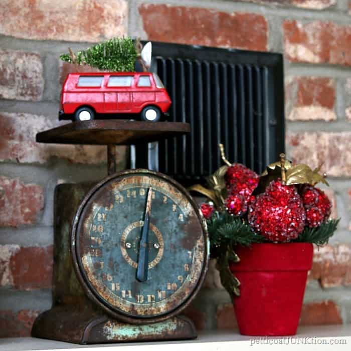 rusty vintage kitchen scale with red van topped with Christmas tree