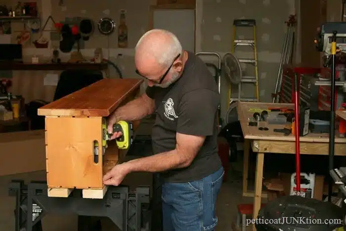 attaching the 2 x 4 to the wood crates