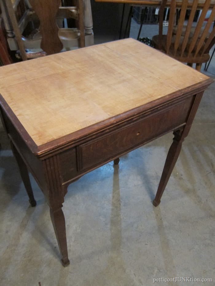 Removing An Antique Sewing Machine From The Cabinet