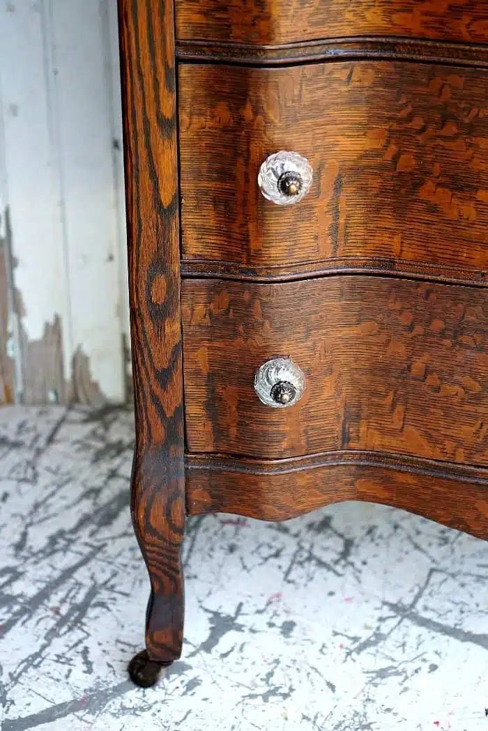 curvy legs and beautiful oak wood of an antique chest of drawers