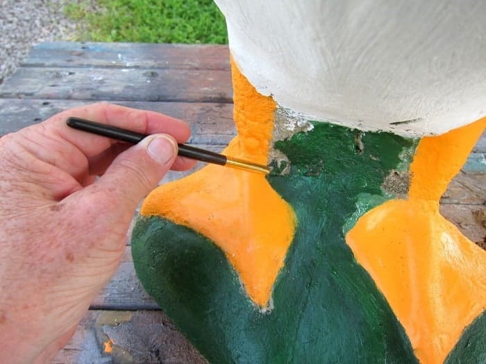 repairing and painting a goose garden statue