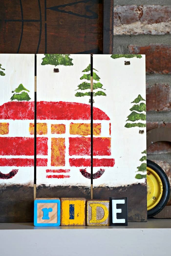 woodland camper wall sign painted in red, green and yellow