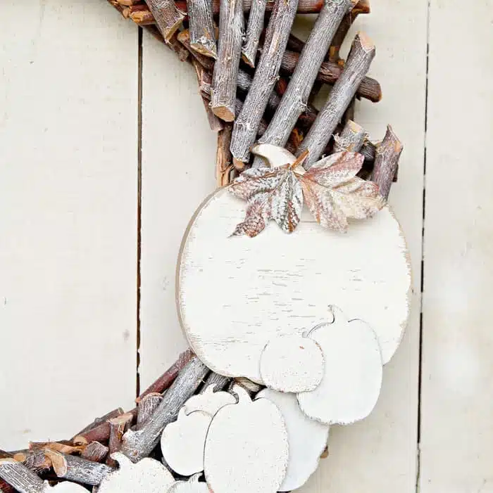 basic wood wreath decorated with pumpkins