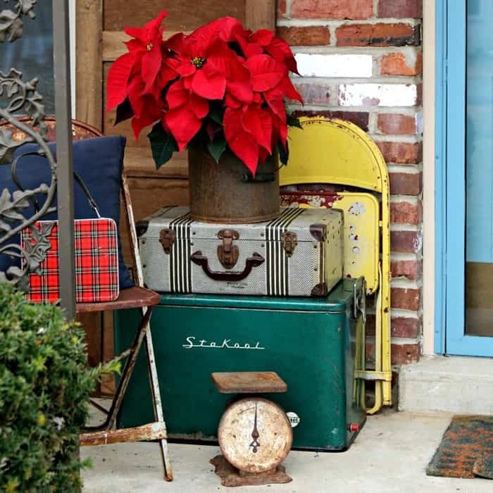 Christmas decorating with vintage luggage and metal chairs