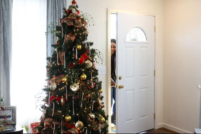 Carrie getting the first look inside her home after Warrick Dunn Charities and Aaron's filled the home with furniture and new decor