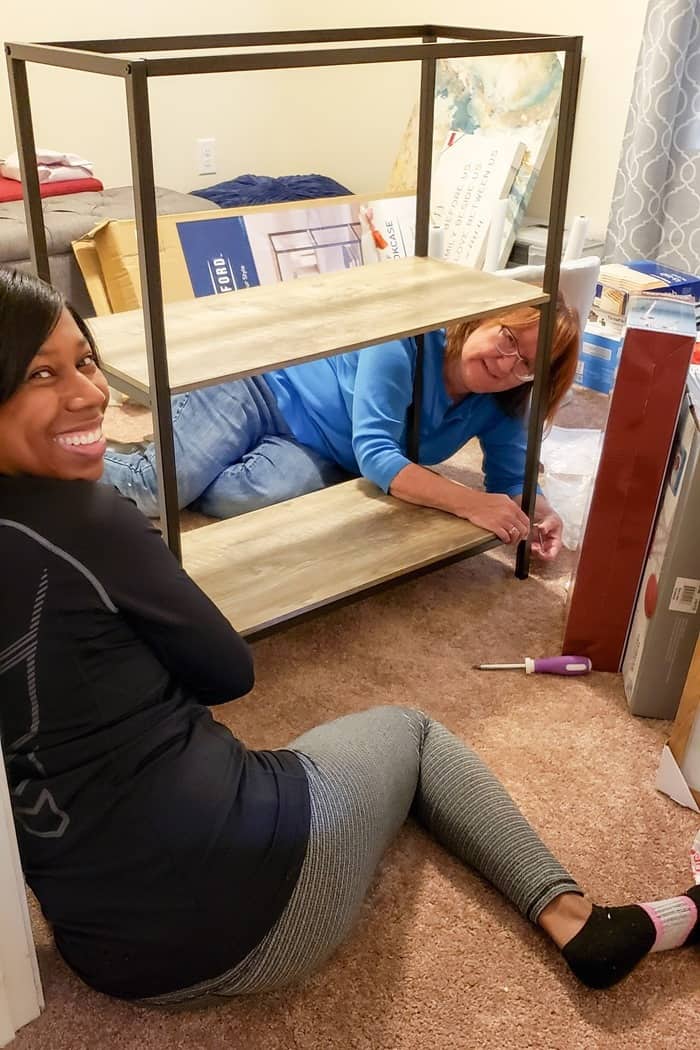 Kathy and Shadonte putting furniture together for Homes for the Holidays Habitat for Humanity house