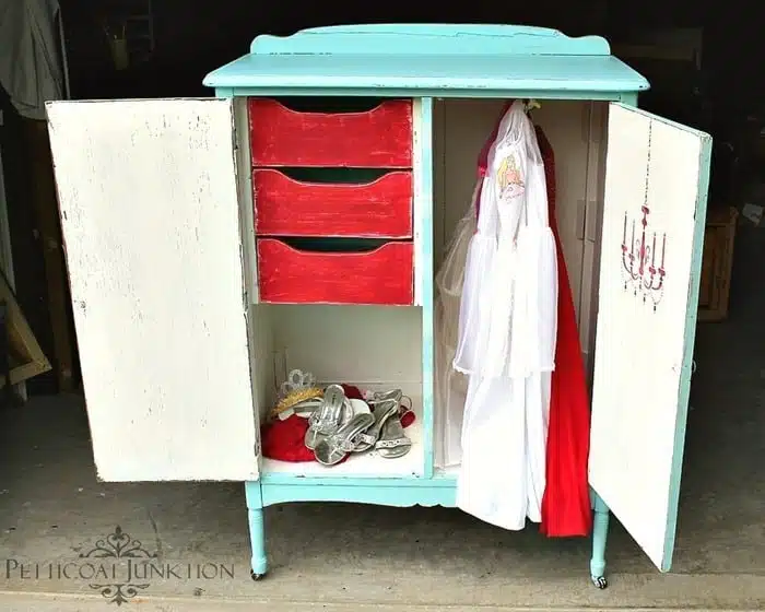Vintage wardrobe painted and stenciled inside and out makes a great place to store kids dress up clothes