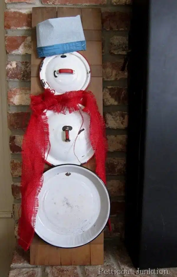 snowman made out of enamel pot lids
