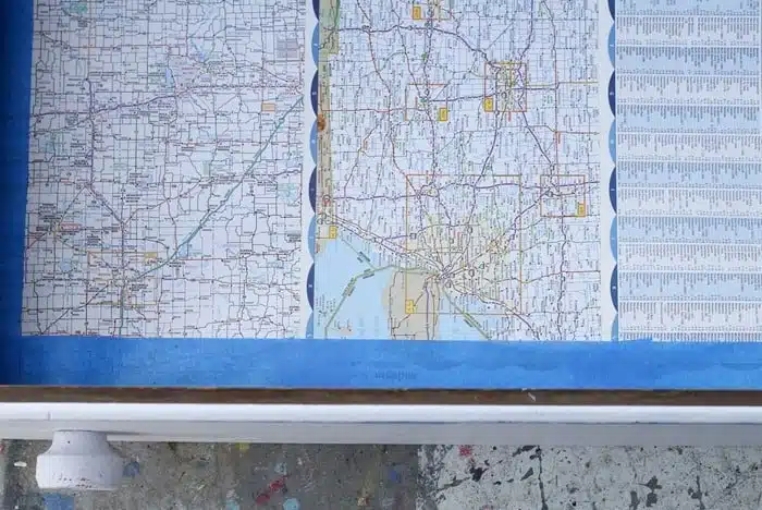 use blue painters tape to secure atlas map pages to furniture drawers for liners