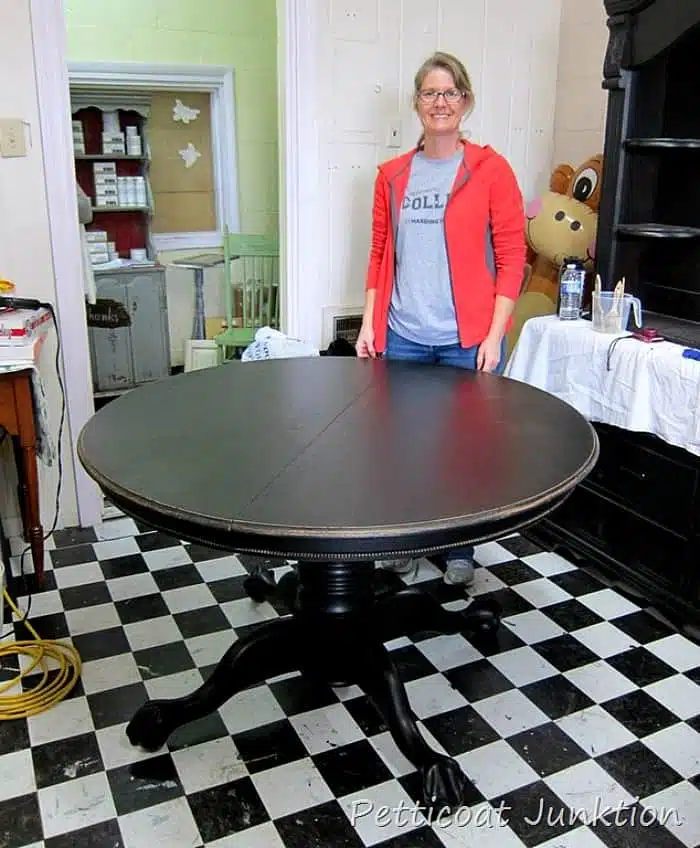 paint a solid wood dining room table black and distress the paint