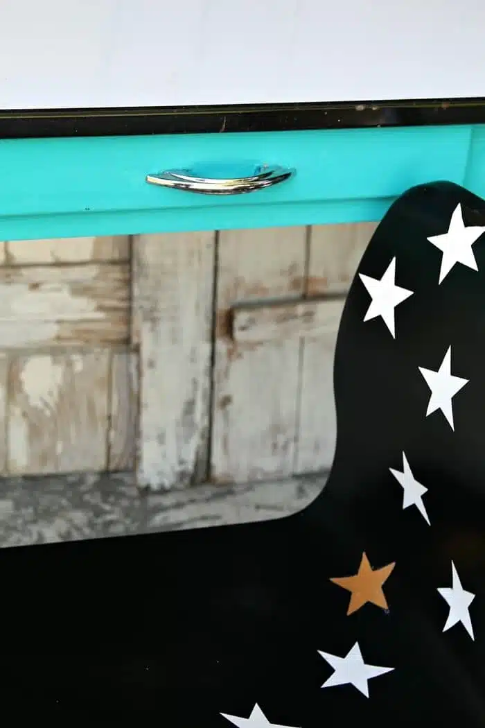 black spray paint and star decals turn a ho hum chair into a work of art