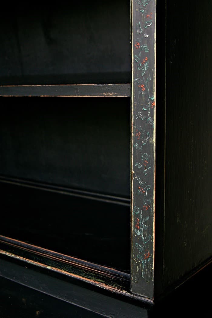 vintage hutch is painted black and distressed 