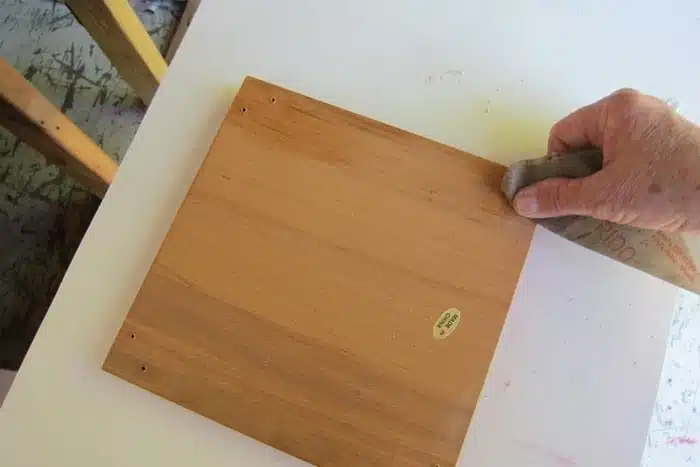 using sandpaper to smooth rough wood