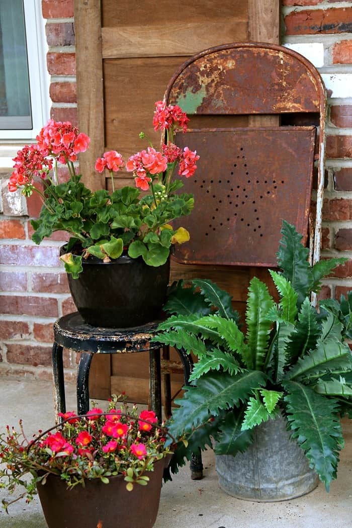 Summer porch decorating with rusty flower pots and rustic decor