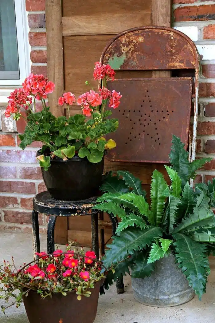 Summer porch decorating with rusty flower pots and rustic decor