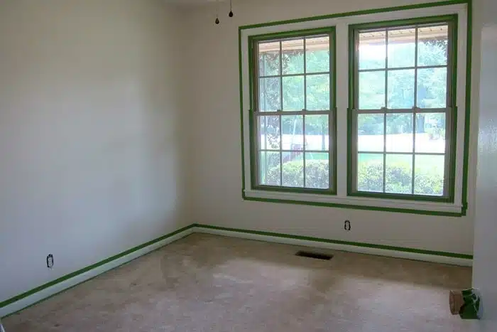 bedroom ready to paint using FrogTape to prevent paint from getting on walls and windows