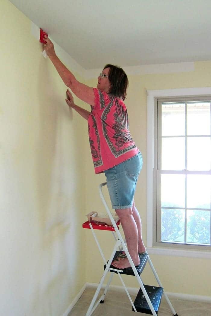 cutting in the wall where it meets the ceiling with a paint pad cutting in the wall where it meets the ceiling with a paint pad