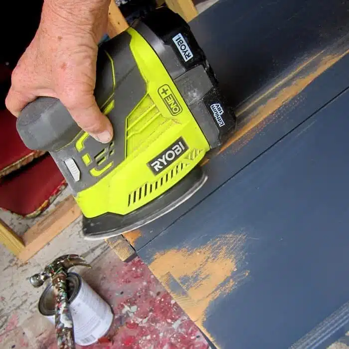distressing painted furniture with a power sander
