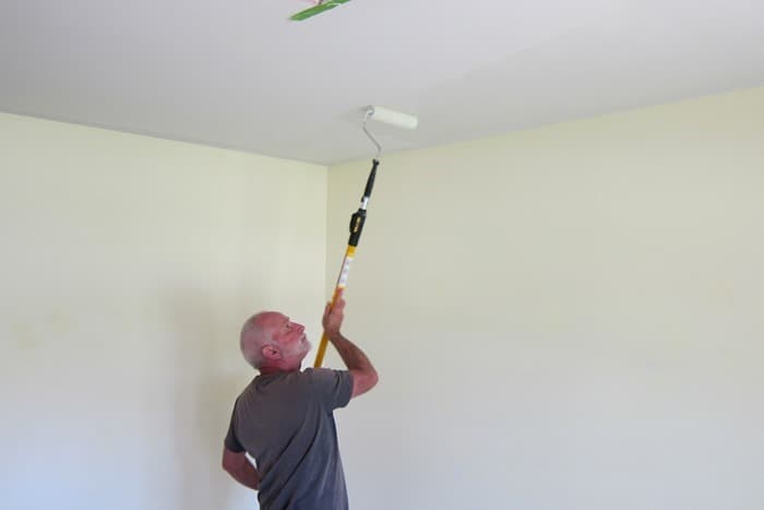 painting the ceiling with a paint pole and roller painting the ceiling with a paint pole and roller